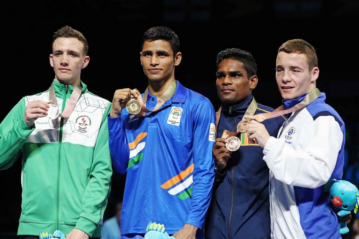 Gold medallist Gaurav Solanki of India, silver medallist Brendan Irvine of Northern Ireland, and bronze medallists M Vidanalange Ishan Bandara of Sri Lanka and Reece McFadden of Scotland. (REUTERS)