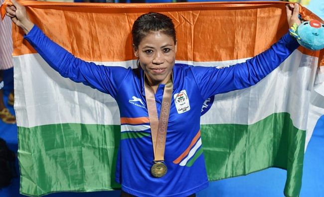 Gold medalist India's MC Mary Kom poses for photographs during the medal ceremony of the women's Light Fly (45-48kg) boxing event at the Commonwealth Games 2018 in Gold Coast, Australia on Saturday. (PTI Photo)