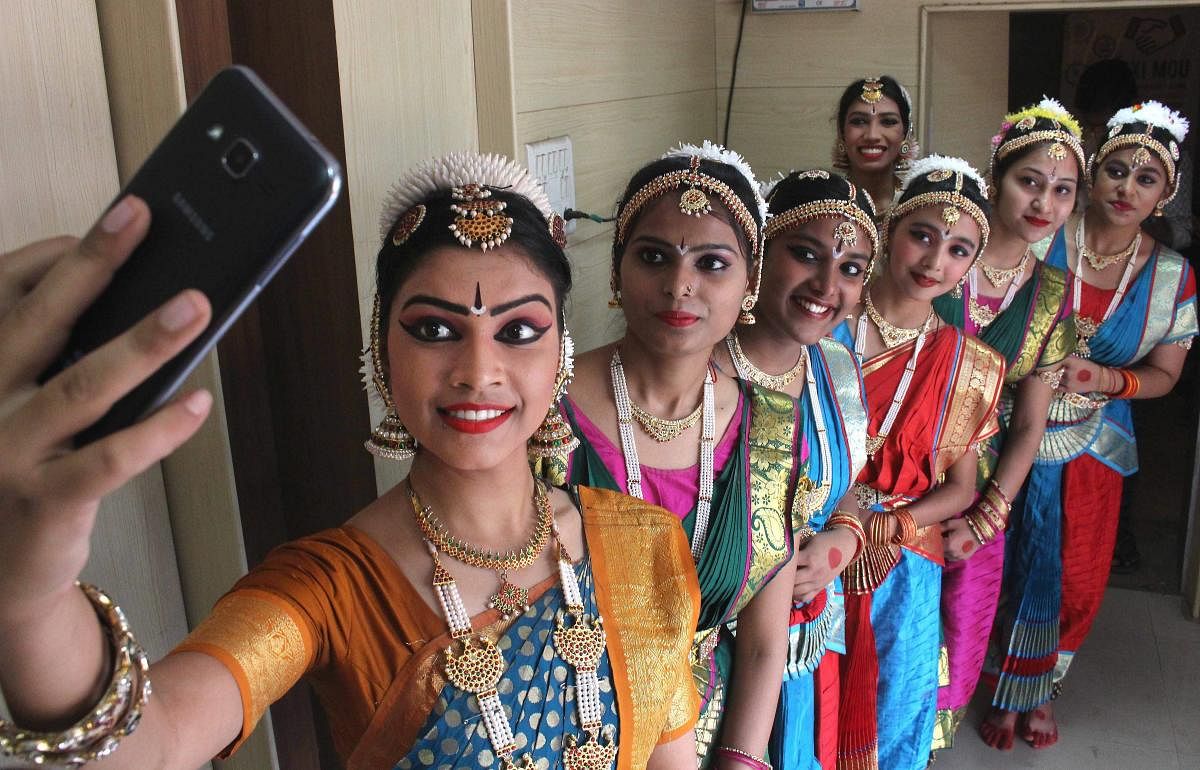Children take selfie during Tamil New Year (Puthuvarudam) celebrations at Bhopal Tamil Sangam on Sunday. PTI
