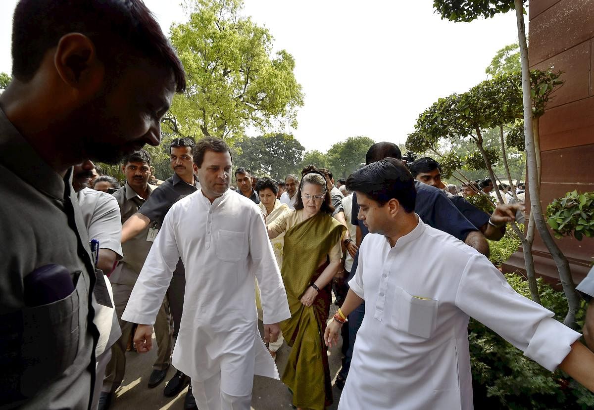 UPA Chairperson Sonia Gandhi and AICC President Rahul Gandhi leave after opposition party's protest in Parliament during budget session in New Delhi on Thursday. (PTI Photo)