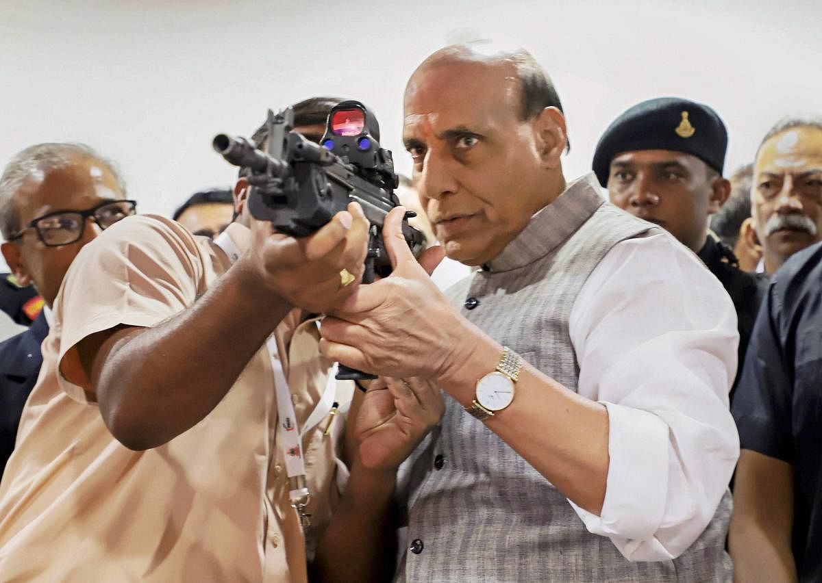 Rajnath Singh checks out a gun during the inauguration of the 2nd Conference of Young Superintendents of Police, organized by the Director General of Bureau of Police Research & Development (BPR&D), in New Delhi. (PTI Photo)