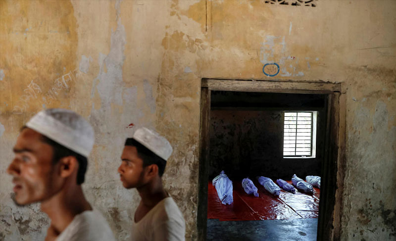 Bodies of Rohingya refugees, who died when their boat capsized while fleeing Myanmar, are placed in a local madrasa in Shah Porir Dwip, in Teknaf, near Cox's Bazar in Bangladesh, October 9, 2017. REUTERS/Damir Sagolj