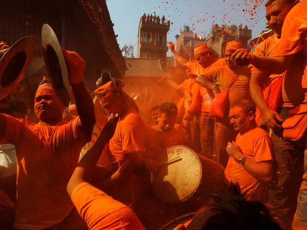 Devotees play traditional musical instruments while celebrating the