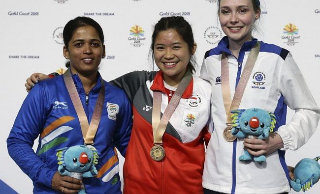 Tejaswini Sawant of India, left, silver medal, Martina Lindsay Veloso of Singapore, center, gold medal, and Seonaid McIntosh of Scotland, right, bronze medal, stand on the podium during the women's 50m Rifle Prone final at the Belmont Shooting Centre during the 2018 Commonwealth Games in Brisbane, Australia, Thursday, April 12, 2018. (AP/PTI Photo)