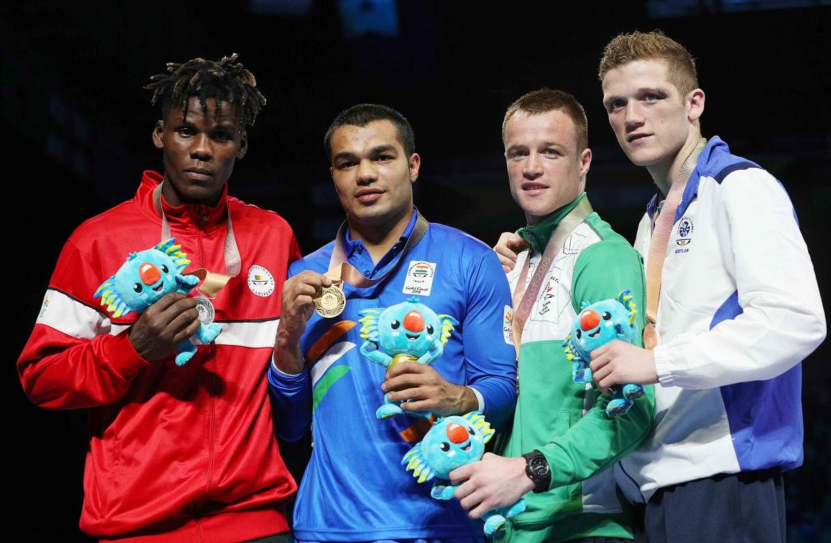Silver medalist Dieudonne Wilfried Seyi Ntsengue of Cameroon, gold medalist Vikas Krishan of India and bronze medalists Steven Donnelly of Northern Ireland and John Docherty of Scotland pose with medals. (REUTERS)