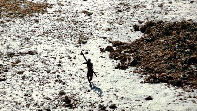 In this handout photo provided by the Indian Coast Guard and Survival International and taken on December 28, 2004, a Sentinelese tribesman aims his arrow at an Indian Coast Guard helicopter as it flies over North Sentinel Island in the Andaman Islands, in the wake of the 2004 Indian Ocean tsunami.