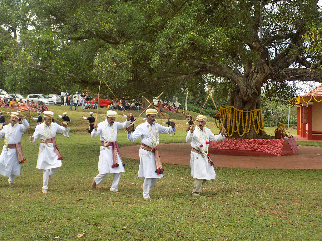 Men performing Kol aat as part of Puthari celebrations. DH File Photo