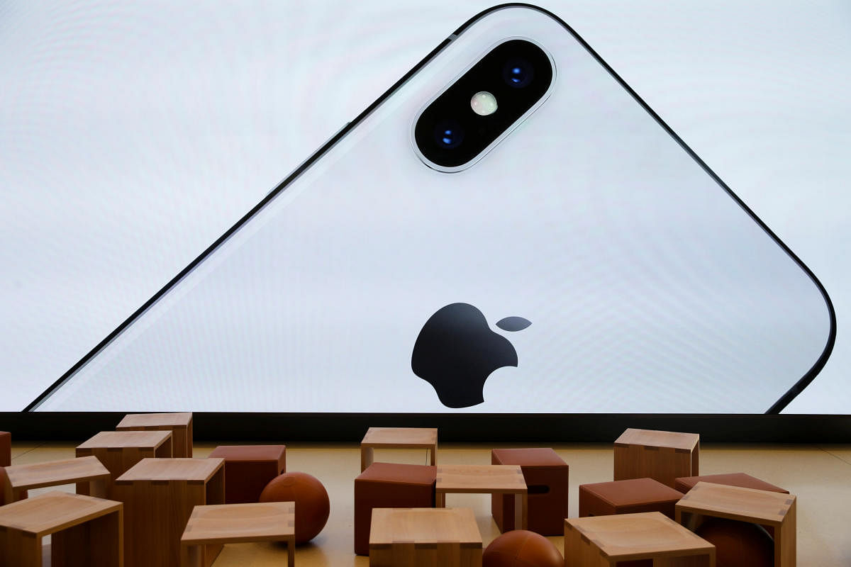 An iPhone X is seen on a large video screen in the new Apple Visitor Center in Cupertino, California, US on November 17, 2017. 