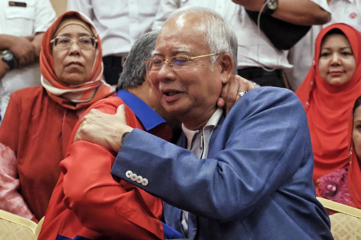 Defeated Malaysian leader, wife barred from leaving country