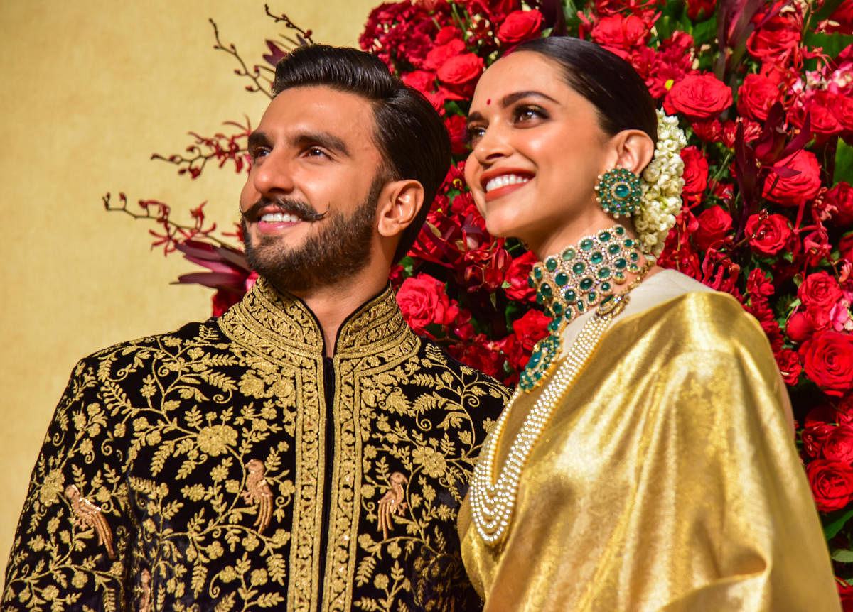 Deepika, Ranveer shine in gold at reception
