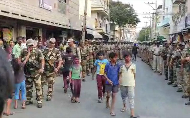 People greet marching military men with floral shower