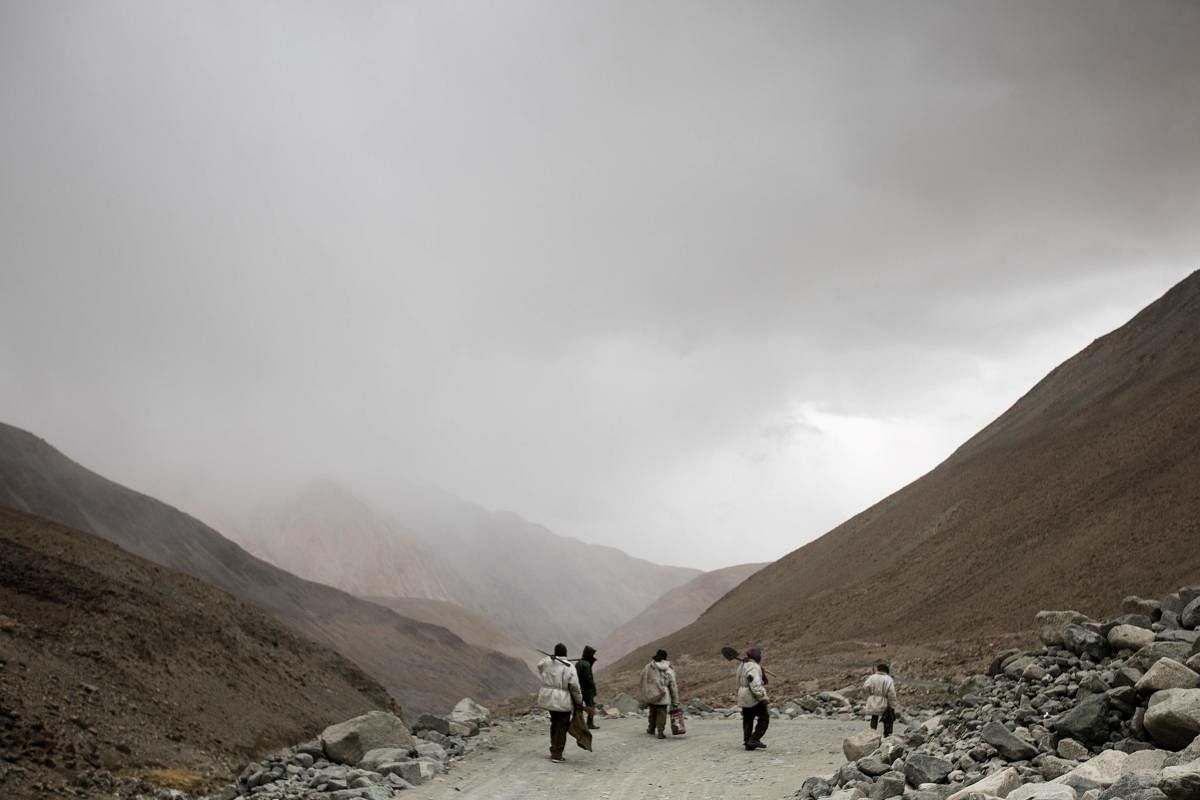 Indian workers toil at one of world's highest roads