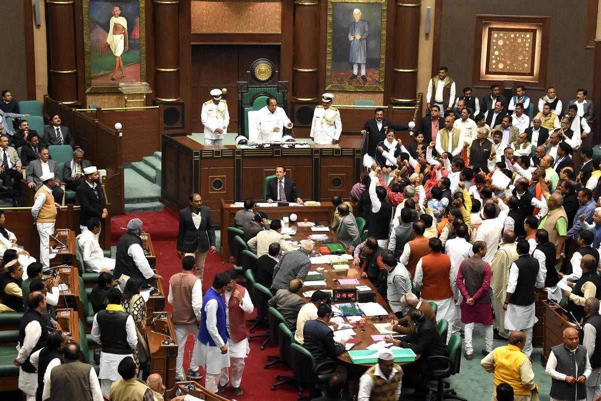Leaders of opposition protest against the election of Deepak Saxena as pro tem speaker during thewinter session of state Assembly, in Bhopal, on Tuesday. Congress MLA N P Prajapati was laterelected Speaker of the 15th Madhya Pradesh Legislative Assembly. (Photo: PTI File Photo)