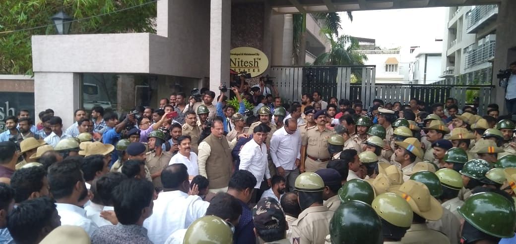 MLA hunt: Cong workers crowd outside apt complex