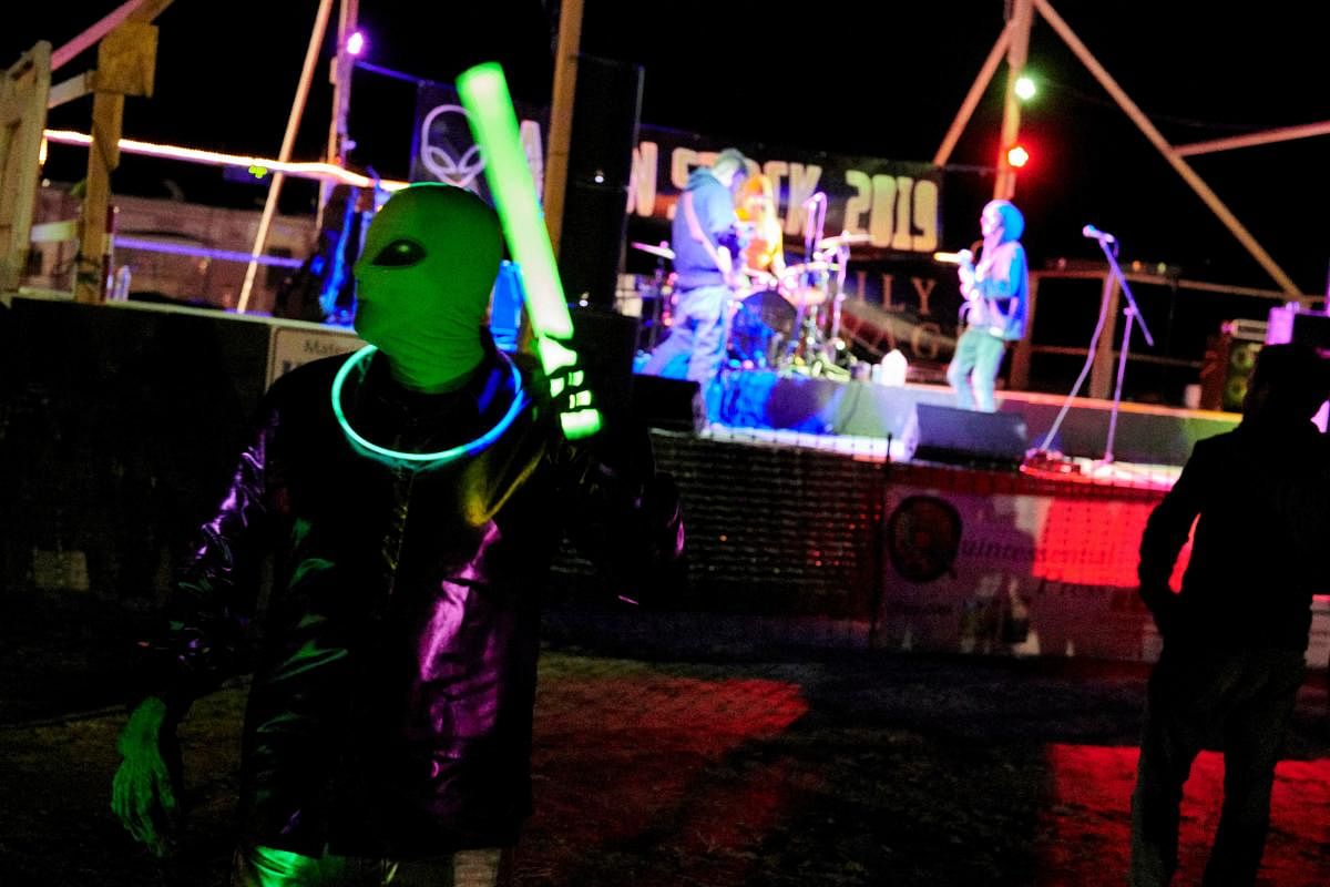 Alien hunters dance to live music during the Alienstock festival on the