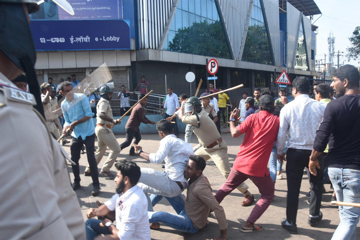 Police cane protesters near DC’s office in Mangaluru.