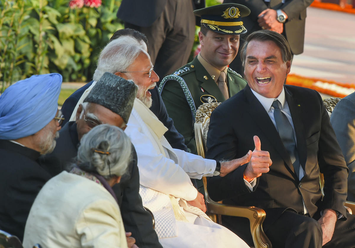 Prime Minister Narendra Modi shares a light moment with Brazilian President Jair Bolsonaro (C) as President Ram Nath Kovind looks on, during the 'At-Home' reception, organised on the occasion of Republic Day at Rashtrapati Bhawan in New Delhi on January 26, 2020.