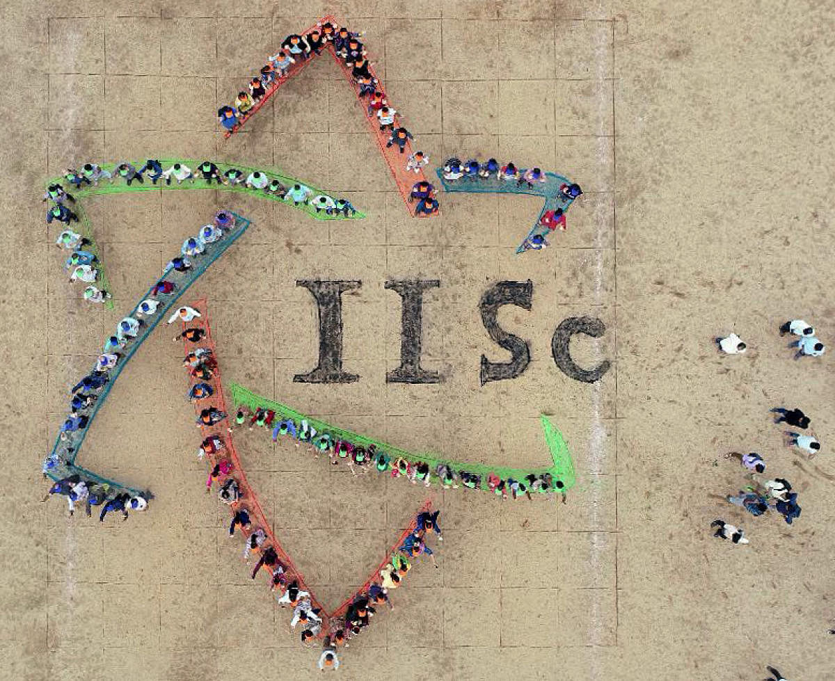 An aerial view of the new IISc logo formed by students, faculty and staff at the IISc campus in Bengaluru on Tuesday. DH Photo