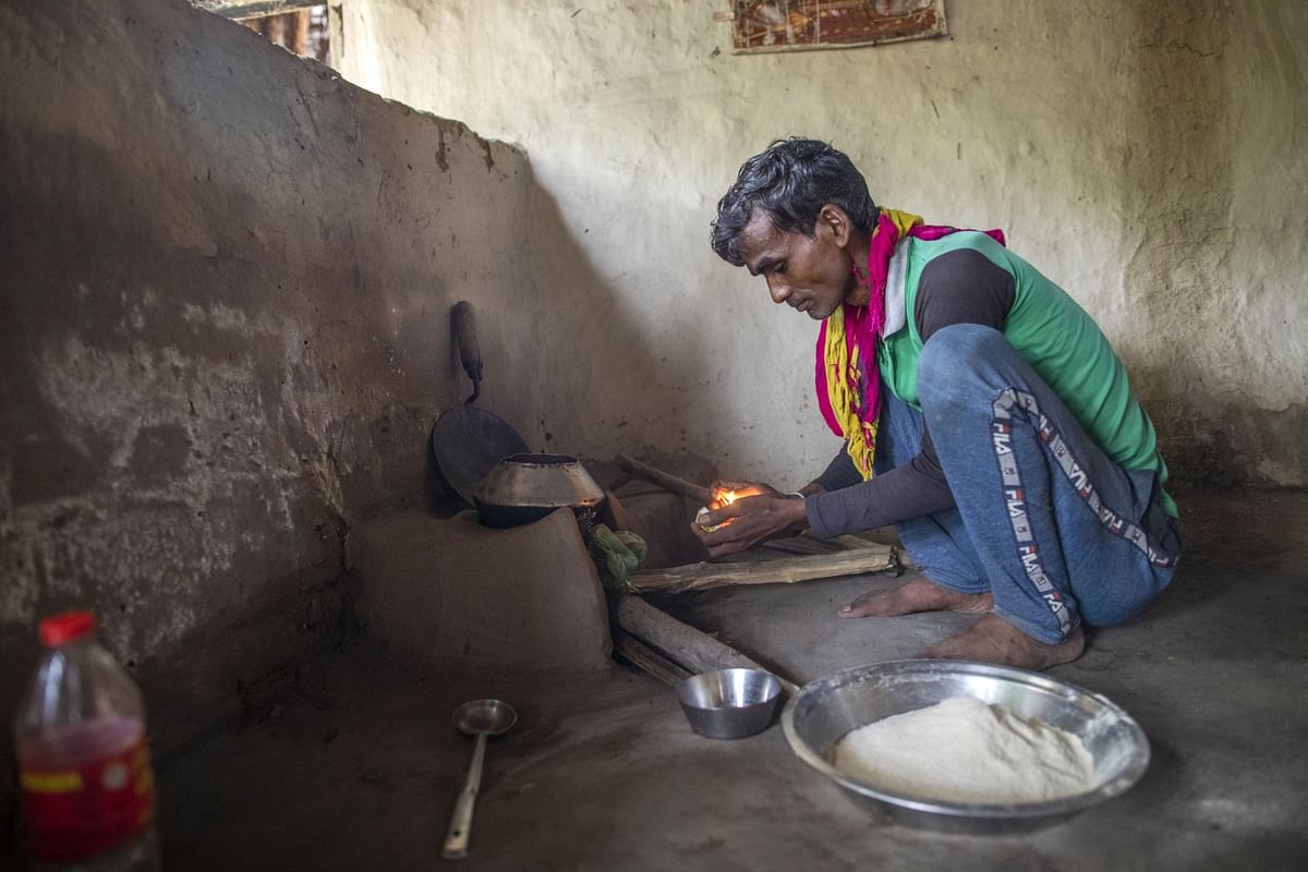 Unemployed migrant worker Ram Kumar prepares to cook at his home in the Banda district. To feed himself, he’s sunken into a debt trap. Photographer: Prashanth Vishwanathan/Bloomberg