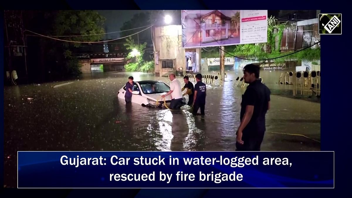 Gujarat: Car stuck in water-logged area, retrieved by fire brigade