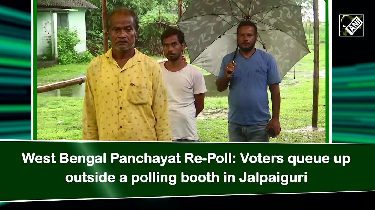 West Bengal Panchayat Re-Poll: Voters queue up outside a polling booth in Jalpaiguri 