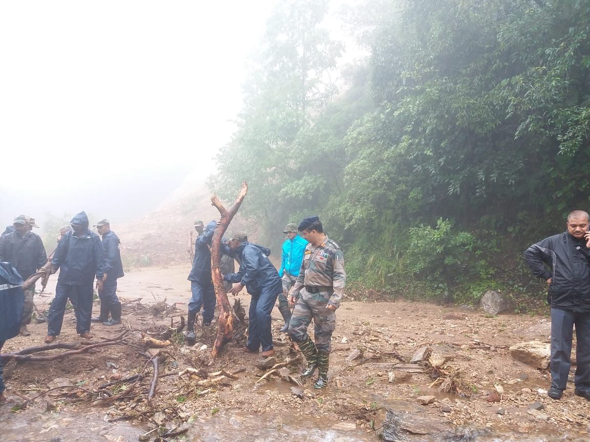 Colonel Kamalesh S Bisht (centre, in beret) watches a group of his troops from the Madras Engineers Group pull a tree at Alehkhan in Chikkamagaluru District.