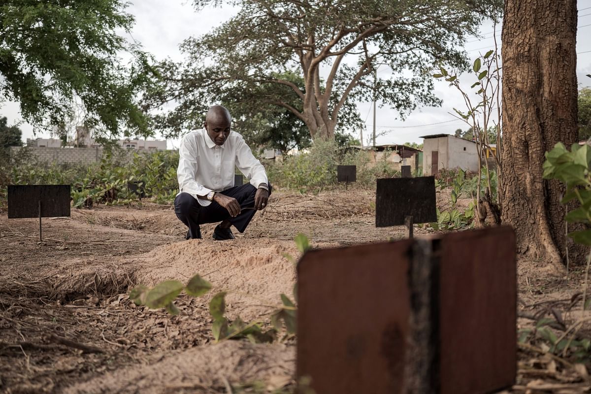 Ebrima Sagnia at the grave of his 3-year-old son, Laimin, in Gambia. Photographer: Annika Hammersclag/Bloomberg