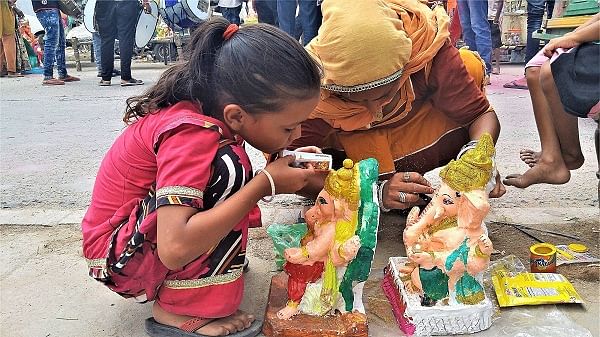 ARTISTIC A mother and child duo give finishing touches to Ganesha idols.