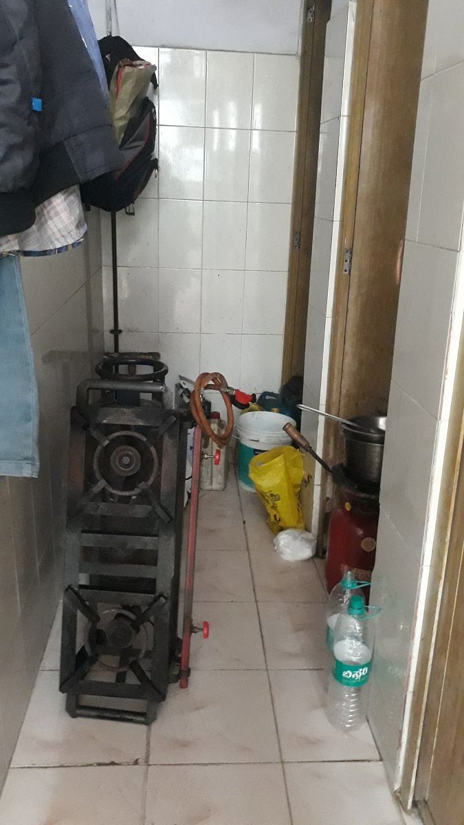 A stove and gas cylinder stored in theladies toilet in Gandhinagar.