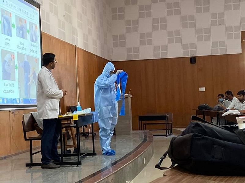A training session for doctors at Victoria Hospitalon how to wear and take off the protective suit.