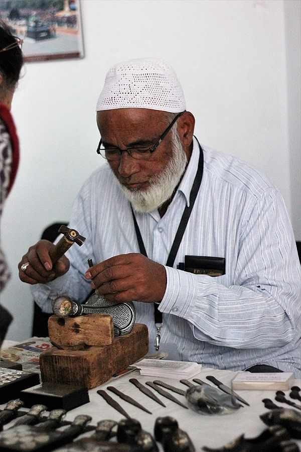 Artisan working on Bidri engraving