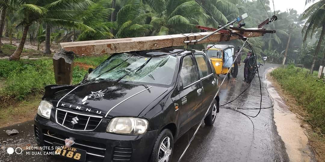Electric pole falls on a car.