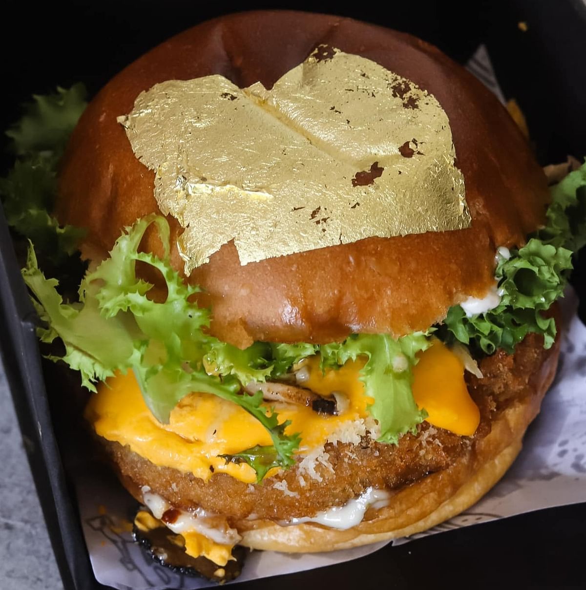 A burger topped with gold leaf from Louis Burger. Credit: Deepa Shri Rajan