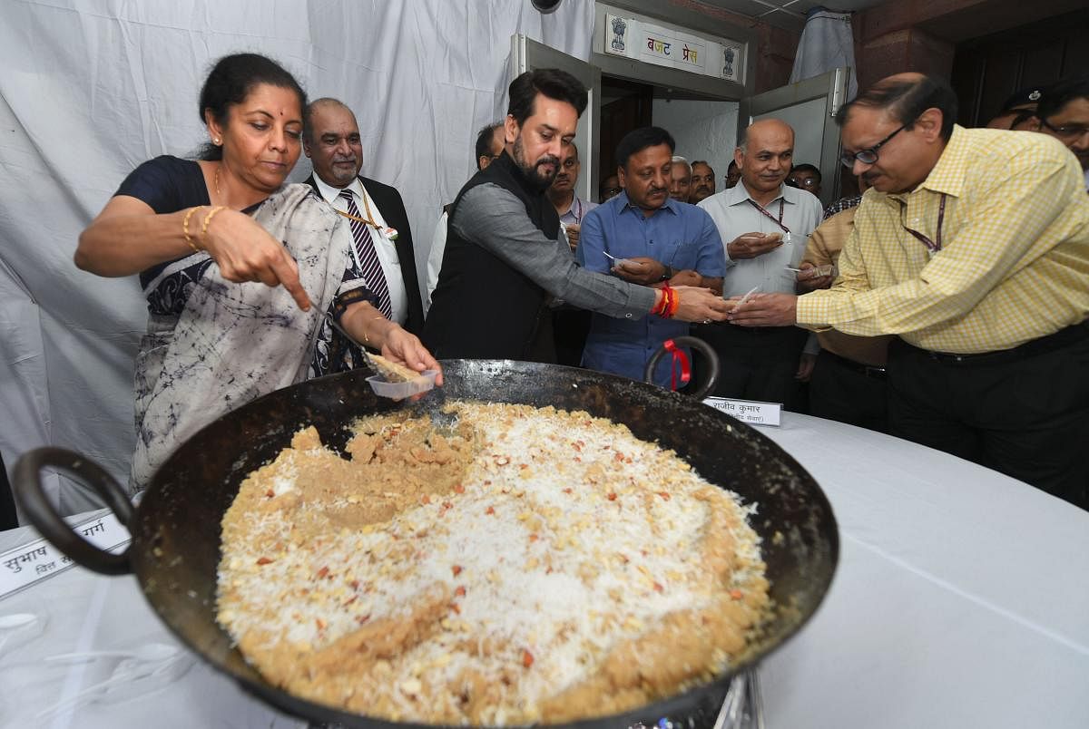 Union Minister for Finance Nirmala Sitharaman and MoS Anurag Thakur distribute halwa to officials during the 'Halwa Ceremony' to mark the beginning of printing of budgetary documents, in New Delhi (PTI Photo)