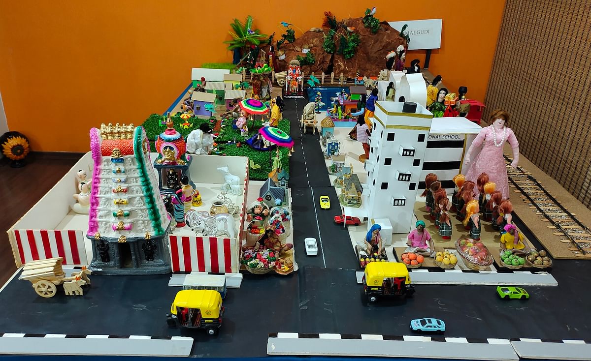 A village scene displayed herefeatures a temple, school and library.