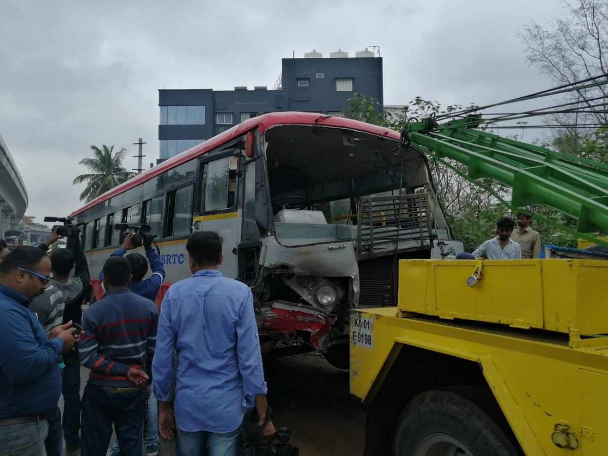 The toppled bus being towed away.