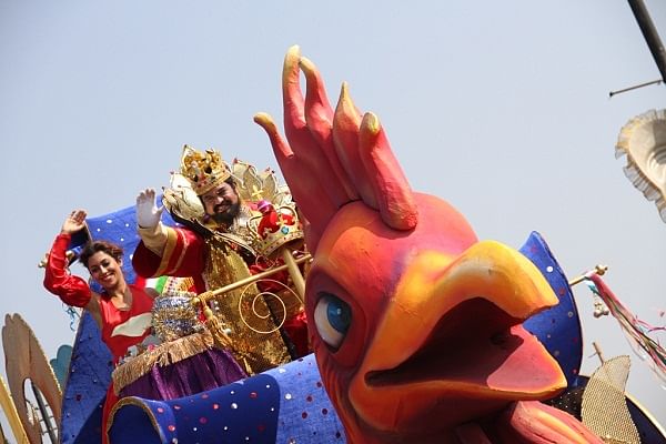 King Momo in a colourful, regal attire atop the leading float.