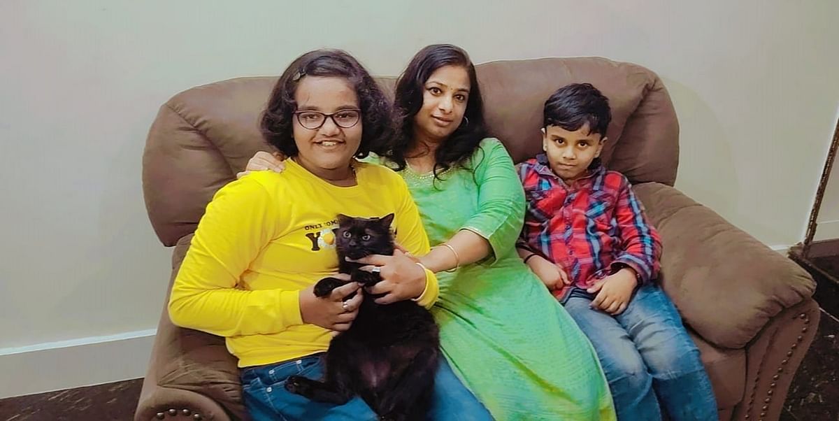 Latha KR with Adithya and Anushkaand their Persian cat Kittu.