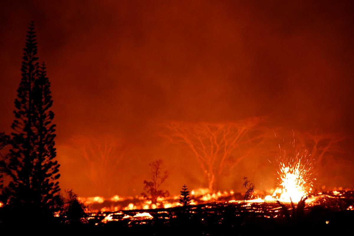 Lava erupts on the outskirts of Pahoa during ongoing eruptions of the Kilauea Volcano in Hawaii, U.S., May 18, 2018. REUTERS
