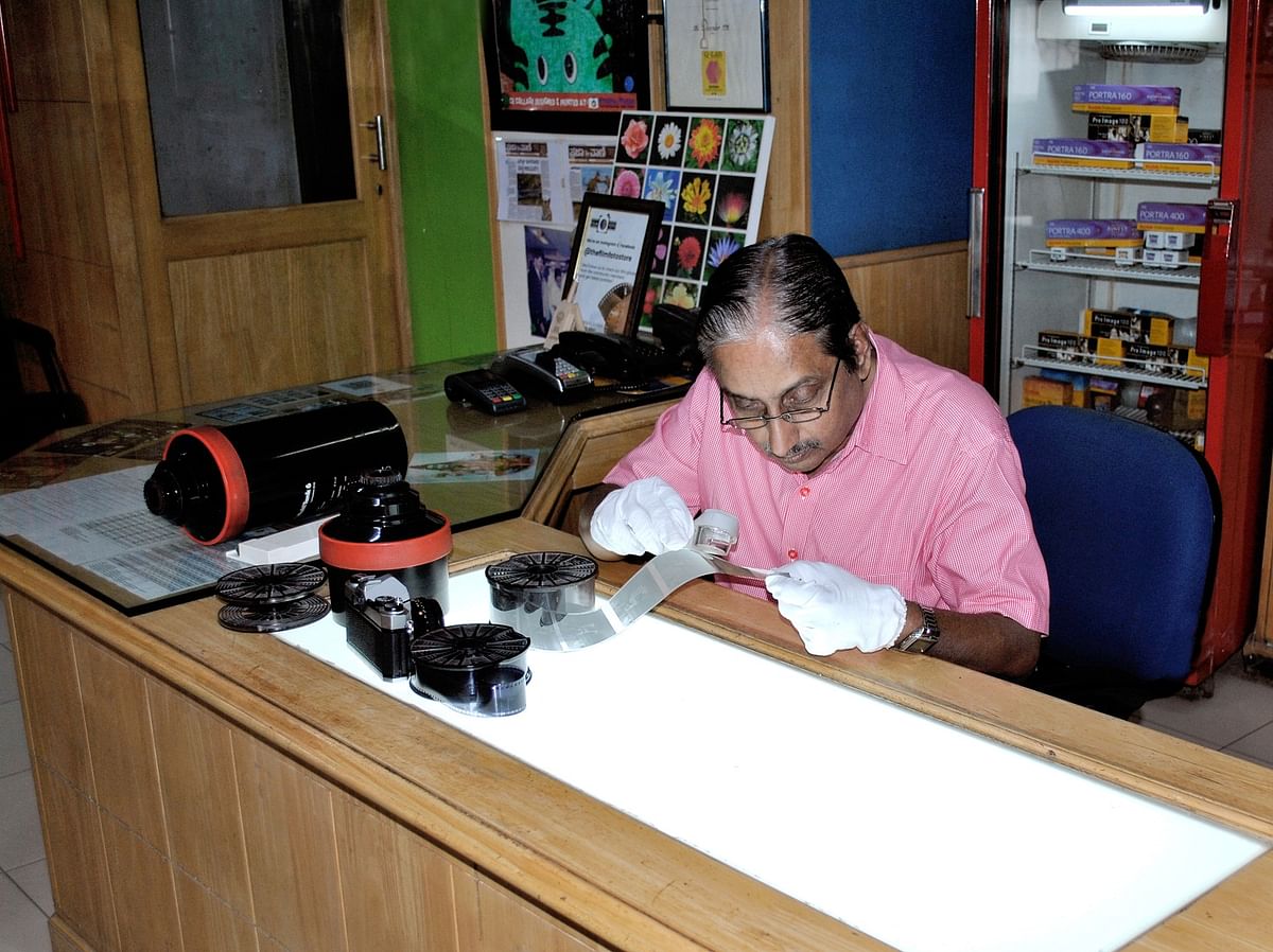 Allama Prabhu looking at thedeveloped negatives.