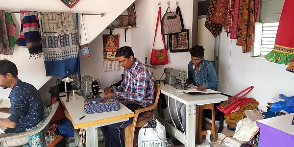 Nilesh Bhimji's relatives pitch in with work at his workshop