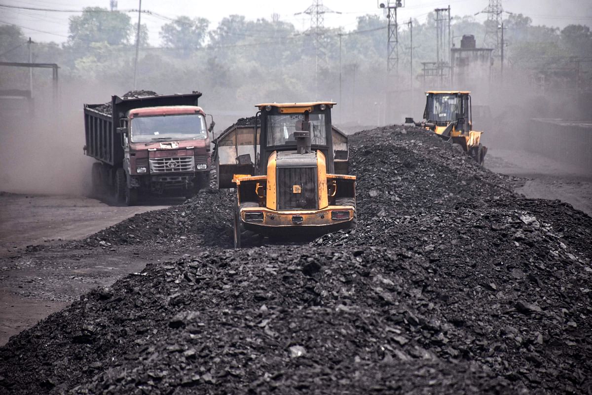 Labourers carry coal onto goods train at Ashoka Coal Mines in Peeparwar, amid a power crisis due to shortage of coal, about 70 Kms from Ranchi. Credit: PTI Photo