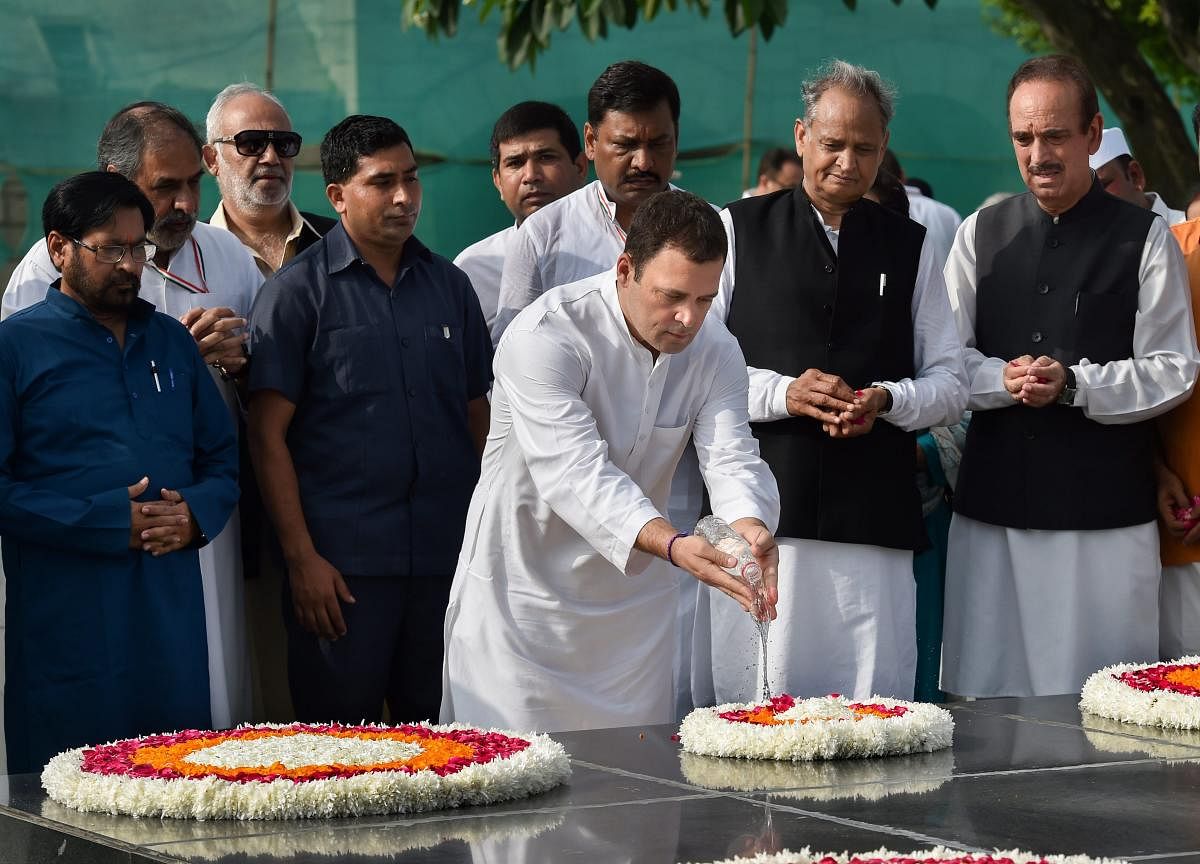 Congress president Rahul Gandhi offers 'holy water'from the Mansarovar Lake at Raj Ghatbefore kick-starting the nationwide protestagainst rising fuel prices, in New Delhi on Monday. (PTI Photo)