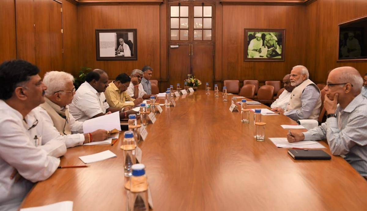 Karnataka Chief Minister H D Kumaraswamy-led delegation during a meeting with Prime Minister Narendra Modi on Monday at New Delhi. The delegation sought funds to take up relief works in flood-hit areas of the state. Former prime minister H D Deve Gowda (seated beside Modi) was also part of the delegation. (Pic released by Press Information Bureau)
