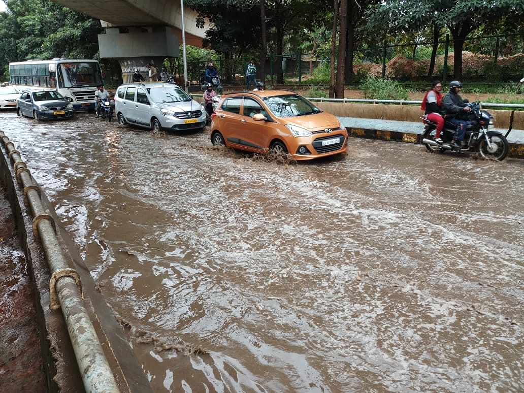 The overnight rain led to waterlogging at Hebbal flyover. (DH Photo/Janardhan B K)