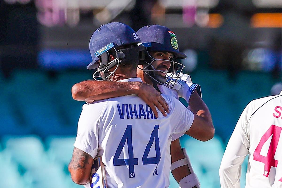 India's Ravichandran Ashwin embraces his teammate Hanuma Vihari at the end of the third cricket Test match between Australia and India at the Sydney Cricket Ground (SCG) in Sydney on January 11, 2021. Credit: AFP Photo