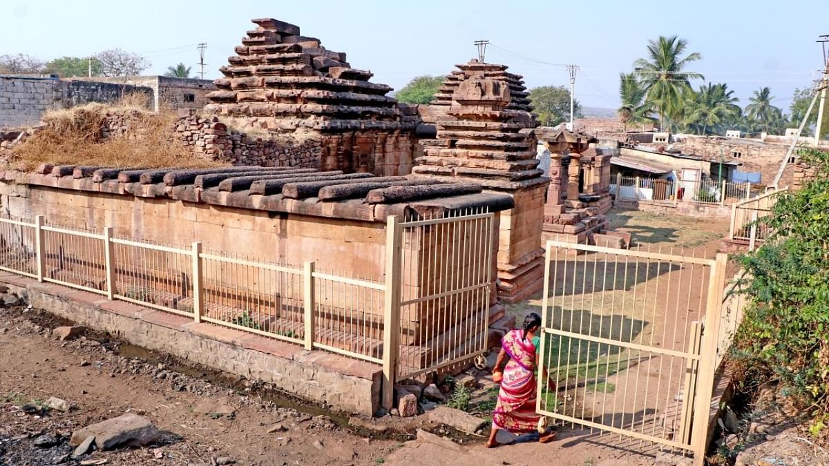 A woman entering Tryambak temple premises to defecate in open in Aihole, the cradle of Indian temple architecture.