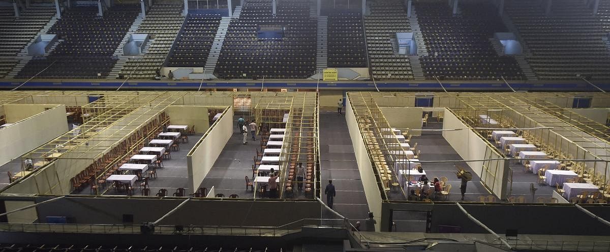 Labourers work inside the Netaji Indoor Stadium as part of preparations for counting day of the West Bengal Assembly Poll, in Kolkata, Saturday, May 1, 2021. Credit: PTI Photo