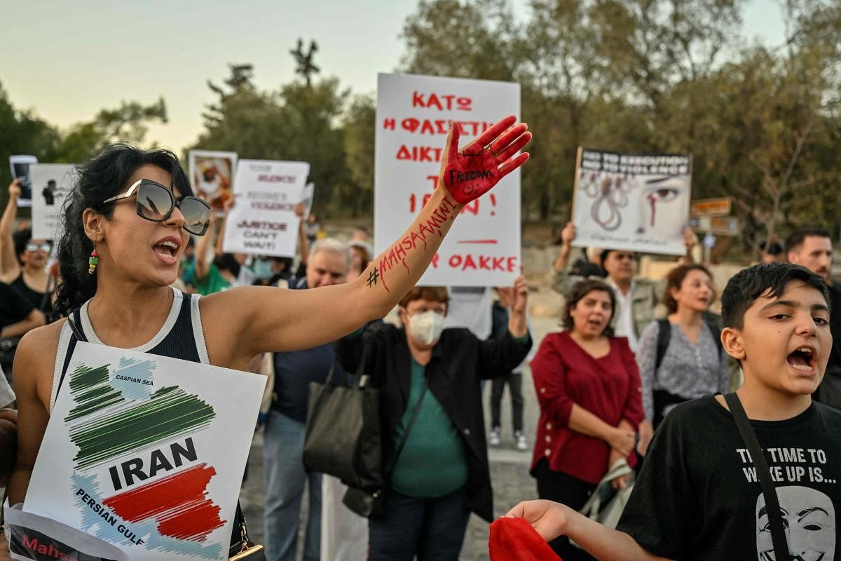 Iranians living in Athens hold placards during a protest in solidarity with Iranians fighting for their freedom. Credit: AFP Photo