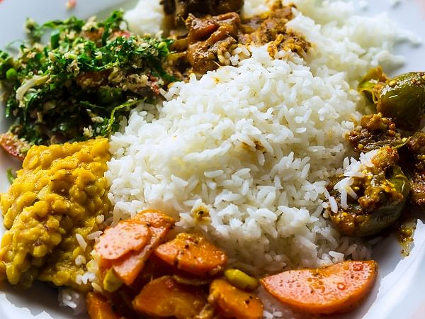 Boiled or steamed rice served with a curry of fish, mutton or chicken, along with other curries made of vegetables, lentils or fruits.